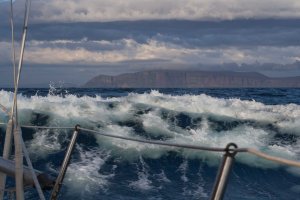 Wind against tide surfing our way to the Orkneys (in the distance)